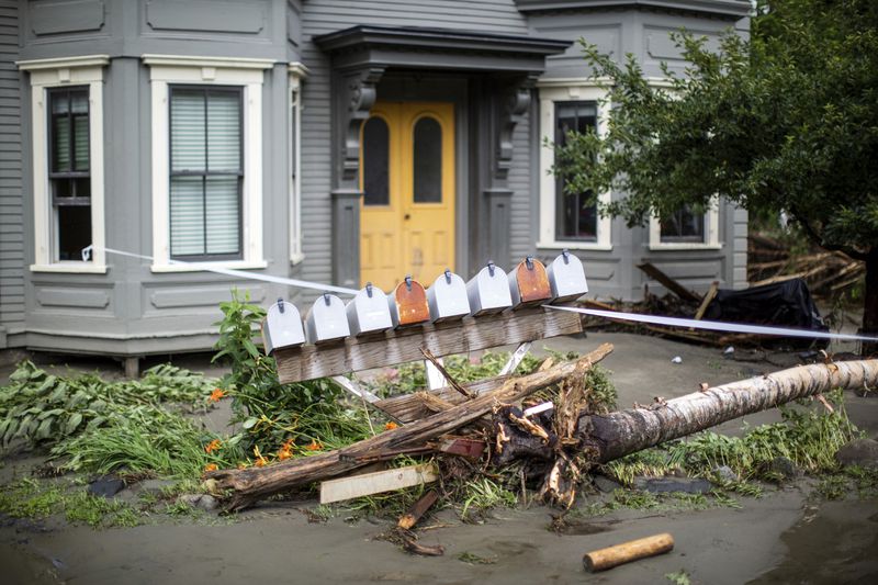 Debris and damaged mailboxes sit outside a home following flooding caused by the remnants of Hurricane Beryl, Thursday, July 11, 2024, in Plainfield, Vt. (AP Photo/Dmitry Belyakov)