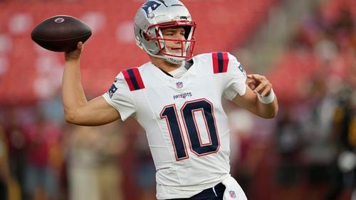 New England Patriots quarterback Drake Maye warms up before a preseason NFL football game against the Washington Commanders, Sunday, Aug. 25, 2024, in Landover, Md. (AP Photo/George Walker IV)