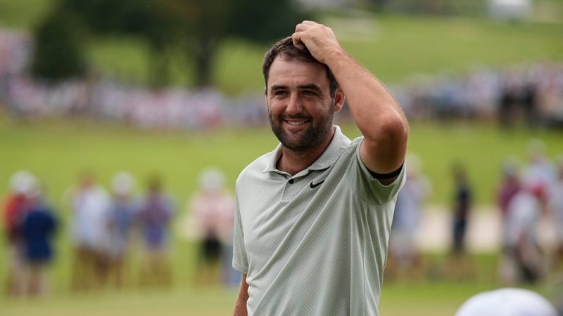 Scottie Scheffler celebrates winning on the 18th green the final round of the Tour Championship golf tournament, Sunday, Sept. 1, 2024, in Atlanta. (AP Photo/Mike Stewart)