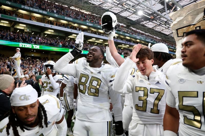 Georgia players celebrate after the NCAA college football game between Georgia Tech and Florida State at the Aviva stadium in Dublin, Saturday, Aug. 24, 2024. (AP Photo/Peter Morrison)