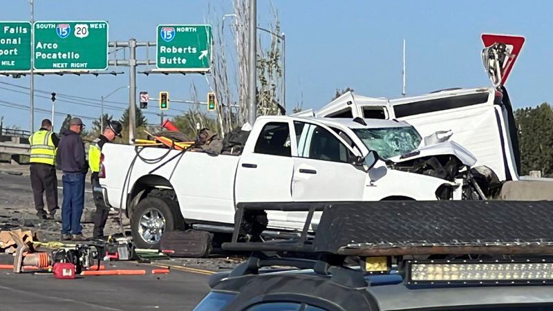In this photo provided by KIFI Local News 8, a pickup truck crashed into a passenger van on U.S. Highway 20, Saturday, May 18, 2024, in Idaho Falls, Idaho. State police say the accident happened Saturday morning when a pickup crossed the centerline on U.S. Highway 20 and fatally hit a passenger van. (Jeff Roper/KIFI Local News 8 via AP)