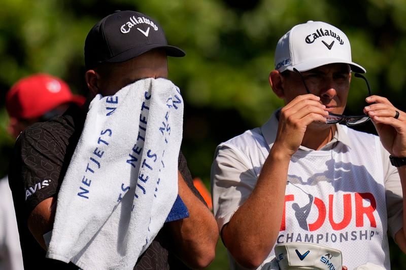 Xander Schauffele wipes sweat off his face on the 12th tee during the first round of the Tour Championship golf tournament, Thursday, Aug. 29, 2024, in Atlanta. (AP Photo/Mike Stewart)