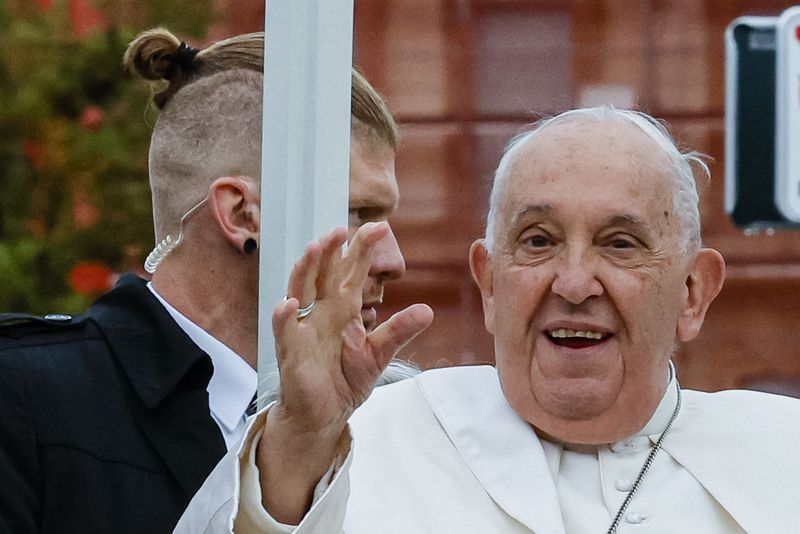 Pope Francis, flanked by security, tours Place de Metz in Luxembourg on the first day of Francis's four-day visit to Luxembourg and Belgium, Thursday, Sept. 26, 2024. (AP Photo/Geert Vanden Wijngaert)