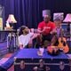 Actor Justin McCoy, seated on the floor, portrays Tony, a father who wants to be closer to his young son in the play "Struggles of a Father's Love." Tony is speaking to his best friend portrayed by actor Garnett Galloway. Courtesy Teresa Edwards