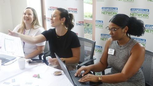 (From left) Brittany Gunter, Mattie Brazelton, and Jordyn Vargas, talk to potential future employers for Veterans Networks and Young Professionals Network at Jackson Healthcare HQ on Thursday, July 27, 2023 in Alpharetta. (Michael Blackshire/Michael.blackshire@ajc.com)