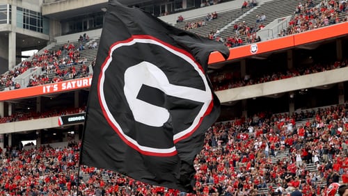 A Georgia flag is run onto the field before the G - Day game at Sanford Stadium Saturday, April 16, 2022, in Athens, Ga. (Jason Getz / Jason.Getz@ajc.com)