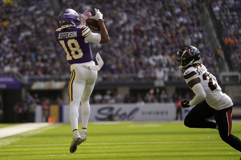 Minnesota Vikings wide receiver Justin Jefferson (18) catches a pass over Houston Texans cornerback Derek Stingley Jr. (24) during the first half of an NFL football game, Sunday, Sept. 22, 2024, in Minneapolis. (AP Photo/Abbie Parr)