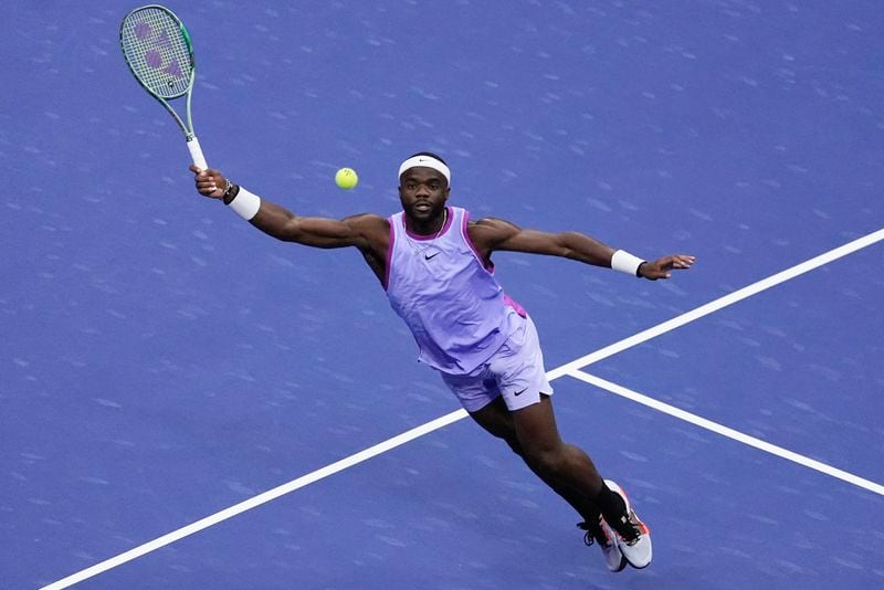 Frances Tiafoe, of the United States, reaches to return a shot from Taylor Fritz, of the United States, during the men's singles semifinal of the U.S. Open tennis championships, Friday, Sept. 6, 2024, in New York. (AP Photo/Julia Nikhinson)