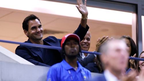 Tennis great Roger Federer waves to the crowd during the quarterfinal match between Aryna Sabalenka, of Belarus, and Zheng Qinwen, of China, during the U.S. Open tennis championships, Tuesday, Sept. 3, 2024, in New York. (AP Photo/Adam Hunger)