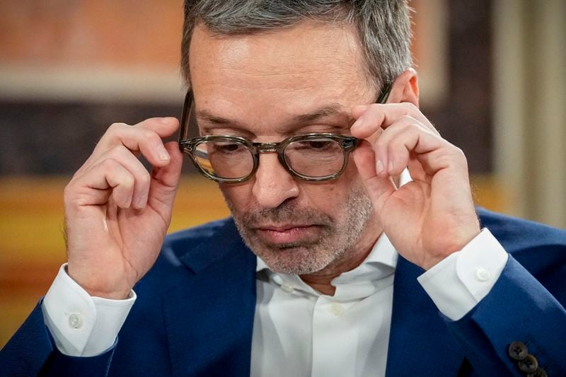 Herbert Kickl, leader of the Freedom Party of Austria adjusts his glasses at the national broadcaster studio, set up in the parliament building, in Vienna, Austria, Sunday, Sept. 29, 2024, after polls closed in the country's national election. (AP Photo/Andreea Alexandru)