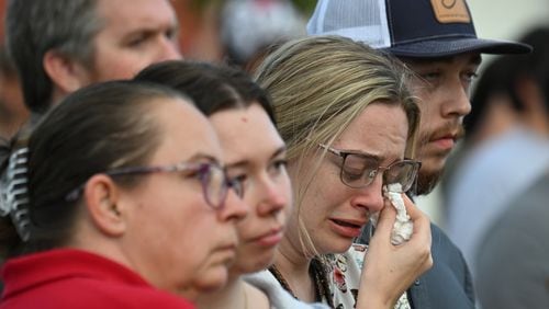 Community members and leaders came together during a community candlelight vigil at Jug Tavern Park on Wednesday. “Fellowship tells us we can’t fix it, but we can help you not go through it by yourself,” the Rev. Dr. Geoffrey Murphy of the Winder First United Methodist Church told the AJC. (Hyosub Shin/AJC)