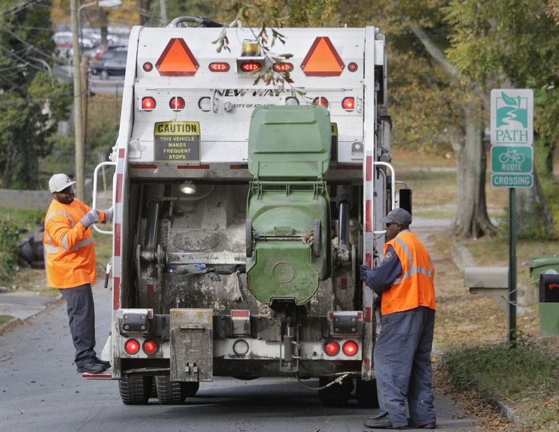 A city of Atlanta garbage crew collects trash in 2012. Bob Andres bandres@ajc.com