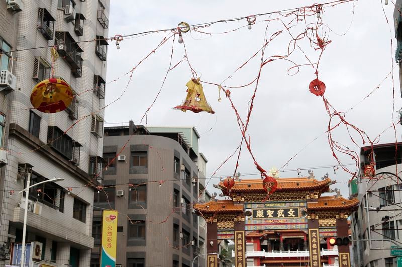 Lanterns destroyed by the wind of Typhoon Krathon, hang outside a temple in Kaohsiung, southern Taiwan, Friday, Oct. 4, 2024. (AP Photo/Chiang Ying-ying)