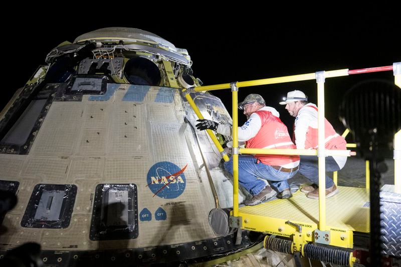 In this photo provided by NASA, Boeing and NASA teams work around NASA's Boeing Crew Flight Test Starliner spacecraft after it landed uncrewed, Friday, Sept. 6, 2024, at White Sands, New Mexico, after undocking from the International Space Station. (Aubrey Gemignani/NASA via AP)