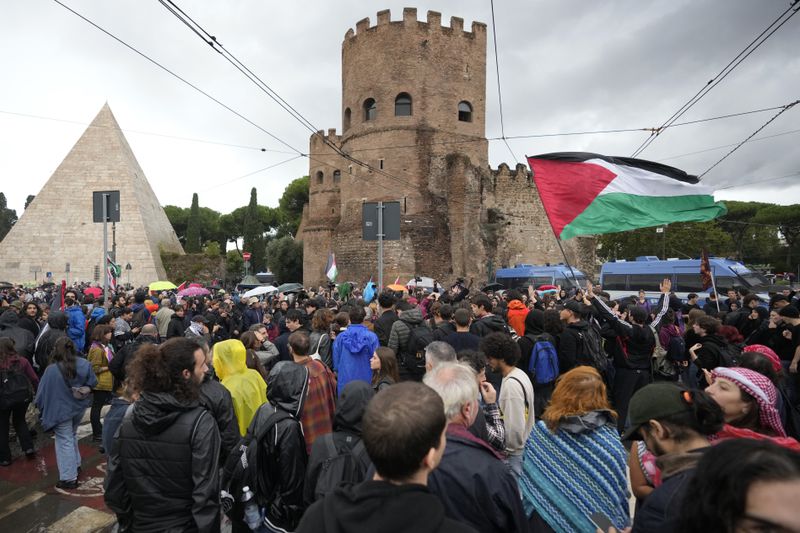 People attend at a protest in Rome, Saturday, Oct. 5, 2024. Pro-palestinians people take to the street in an unauthorised march in the centre of Rome two days ahead of the first anniversary of the Oct. 7. (AP Photo/Andrew Medichini)