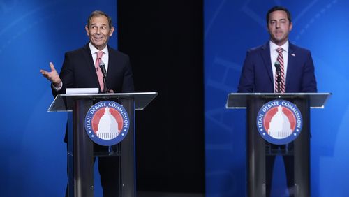 U.S. Rep. John Curtis, left, reacts to a statement made from Trent Staggs, right, during the Utah Senate primary debate for Republican contenders battling to win the seat of retiring U.S. Sen. Mitt Romney, Monday, June 10, 2024, in Salt Lake City. (AP Photo/Rick Bowmer, Pool)