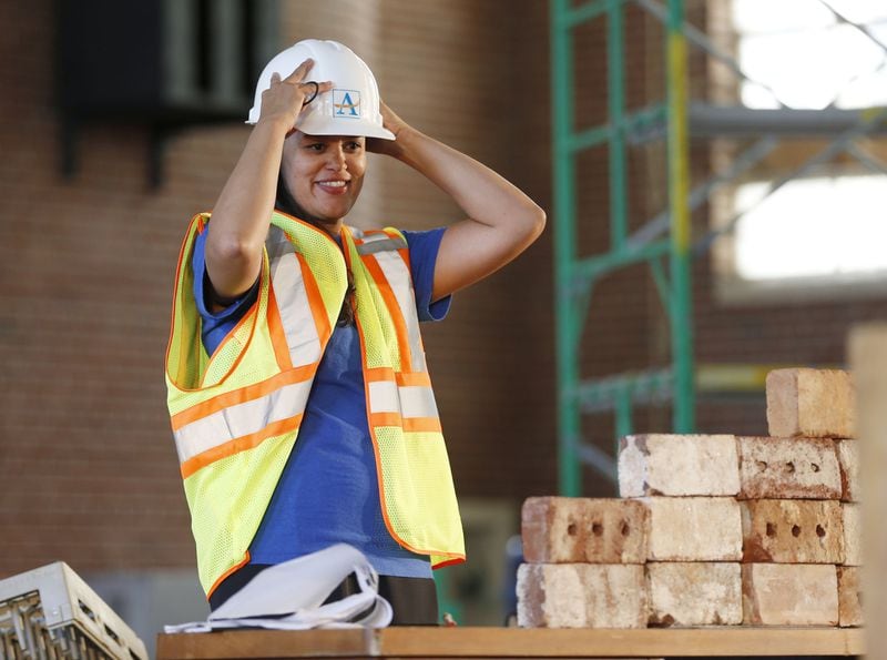 Atlanta Public Schools Superintendent Meria Carstarphen put on a construction hat and vest as she delivered her 2015 State of the District address at the David T. Howard school site. BOB ANDRES / AJC FILE PHOTO