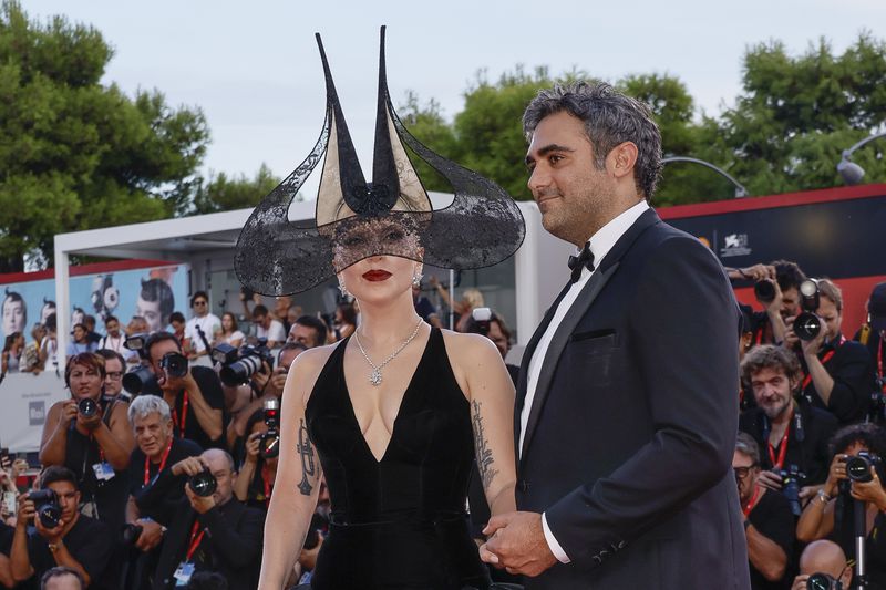 Lady Gaga, left, and Michael Polansky pose for photographers upon arrival for the premiere of the film 'Joker: Folie A Deux' during the 81st edition of the Venice Film Festival in Venice, Italy, on Wednesday, Sept. 4, 2024. (Photo by Joel C Ryan/Invision/AP)