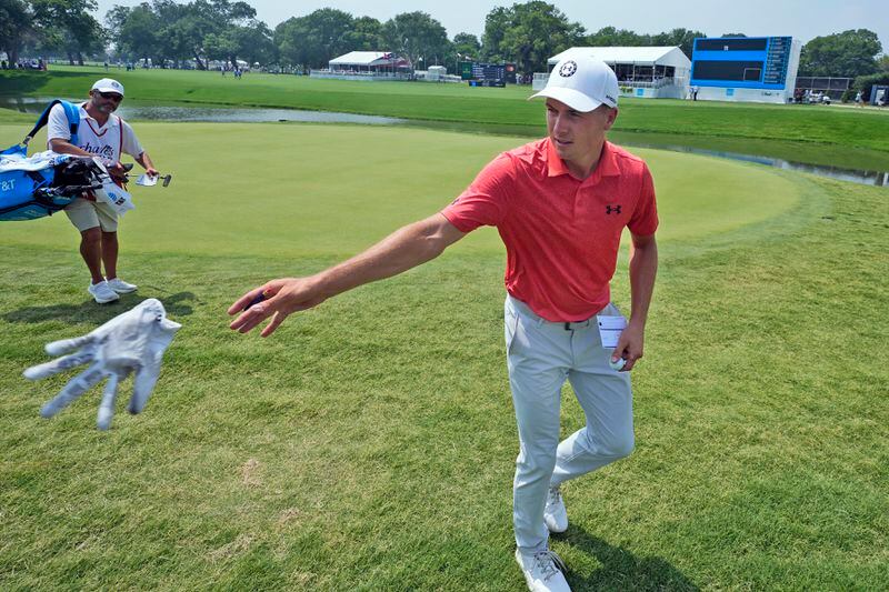 Jordan Spieth tosses gloves to kids in the gallery after playing the 18th hole during the third round of the Charles Schwab Challenge golf tournament at Colonial Country Club in Fort Worth, Texas, Saturday, May 25, 2024. (AP Photo/LM Otero)