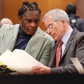 Atlanta rapper Young Thug speaks with defense attorney Brian Steel during his ongoing gang and racketeering trial at Fulton County Courthouse on Tuesday, Jan. 2, 2024. (Natrice Miller/The Atlanta Journal-Constitution/TNS)