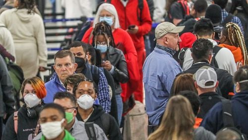 Some passengers wear masks, others don't at Hartsfield-Jackson on April 19, 2022, after a federal judge reversed the federal mask mandate. John Spink / AJC
