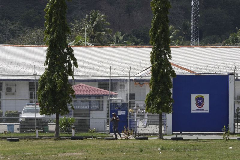 A staff walks outside the prison facility where defrocked American priest Richard Daschbach is serving his 12-year sentence for sex abuse, in East Timor, in Dili, East Timor, Tuesday, Aug. 13, 2024. (AP Photo/Achmad Ibrahim)