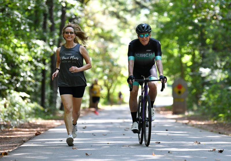 Kevin Avery and Taylor Scott, hosts of "The Kevin & Taylor Show,” exercise on the Silver Comet trail in Smyrna recently. Avery is an avid cyclist and Scott is a big runner. Hyosub Shin / Hyosub.Shin@ajc.com