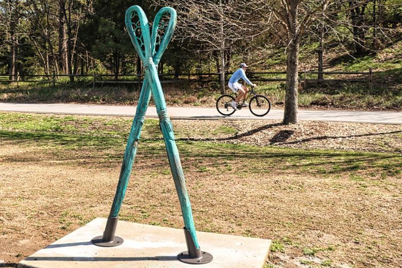 Just off Atlanta’s Beltline near the Historic Fourth Ward Skatepark rises a sculpture depicting a pair of six-foot-long stickball sticks. Called “Little Brother of War,” the artwork was cast in iron, though it was crafted to resemble wood. Its Chickasaw and Choctaw creator, Addison Karl, calls its turquoise-colored patina an ode to his maternal grandfather, who kept a pair of sticks on display in his home in Arizona. Courtesy of Addison Karl