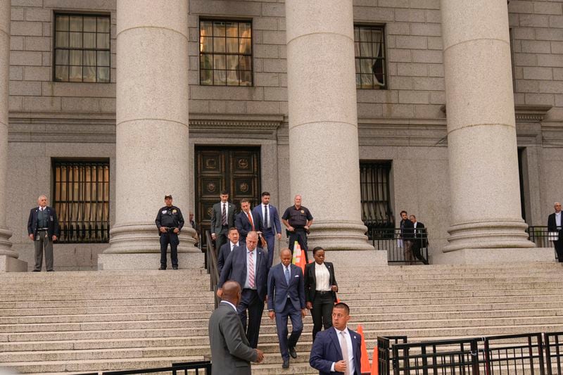 New York City Mayor Eric Adams, center, leaves the courthouse in New York, Wednesday, Oct. 2, 2024. (AP Photo/Seth Wenig)