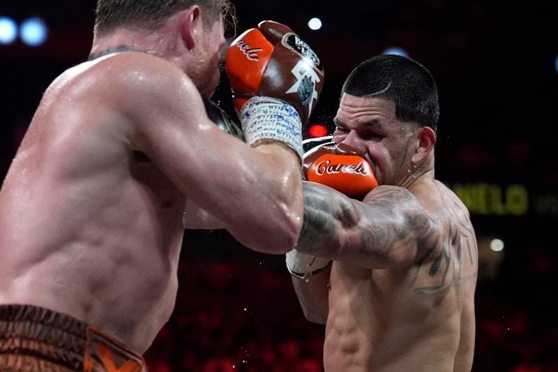 Canelo Alvarez hits Edgar Berlanga in a super middleweight title bout Saturday, Sept. 14, 2024, in Las Vegas. (AP Photo/John Locher)