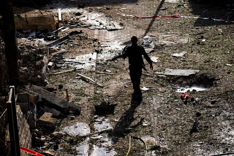 Israeli security forces examine the site hit by a rocket fired from Lebanon, in Kiryat Bialik, northern Israel, on Sunday, Sept. 22, 2024. (AP Photo//Ariel Schalit)