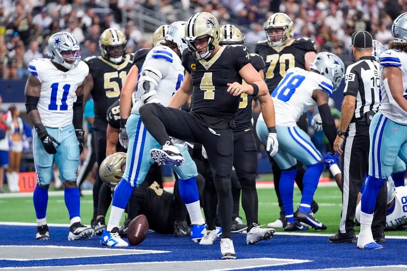 New Orleans Saints quarterback Derek Carr reacts after scoring on a keeper against the Dallas Cowboys during the first half of an NFL football game, Sunday, Sept. 15, 2024, in Arlington, Texas. (AP Photo/Tony Gutierrez)