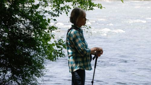 Sally Bethea, enjoys the view of the Chattahoochee River after hiking along the East Palisados trail in Sandy Springs  on Thursday, May 25, 2023. Bethea, the founding director of Chattahoochee Riverkeeper recently released her memoir “Keeping the Chattahoochee” which details the journey of her water conservation efforts in Georgia. (Natrice Miller/ natrice.miller@ajc.com)