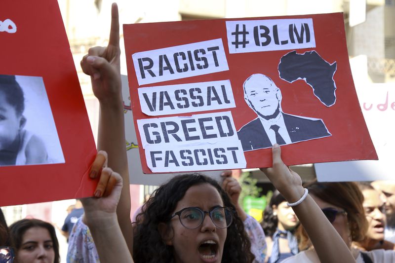 Members of the opposition and civil society groups shout slogans and wave placards during a demonstration against Tunisia president Kais Saied, ahead of the upcoming presidential elections, in Tunis, Friday, Sept. 27, 2024. (AP Photo/Anis Mili)