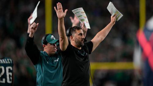 Philadelphia Eagles head coach Nick Sirianni and Kellen Moore, offensive coordinator react to a two-point conversion by Eagles running back Saquon Barkley during the second half of an NFL football game against the Atlanta Falcons on Monday, Sept. 16, 2024, in Philadelphia. (AP Photo/Matt Slocum)