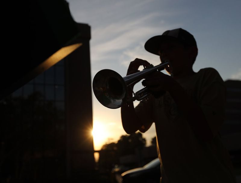 Local sixth grader Jason Zgonc, a member of the Georgia All-State Middle School Band, plays show tunes and classical music on his trumpet outside Emory Decatur Hospital to entertain, thank and inspire the staff. CURTIS COMPTON / CCOMPTON@AJC.COM