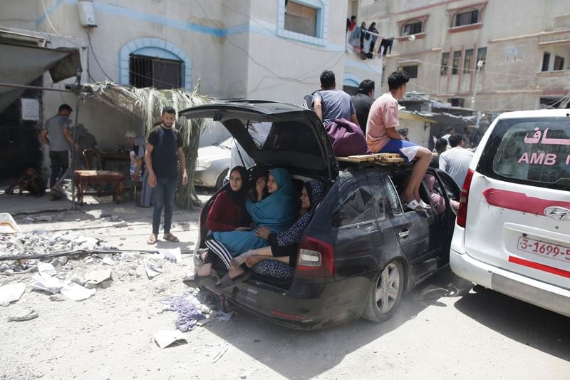 Palestinians evacuate dead and wounded in the Israeli bombardment of the Gaza Strip in Deir al Balah on Saturday, June 8, 2024. (AP Photo/Jehad Alshrafi)