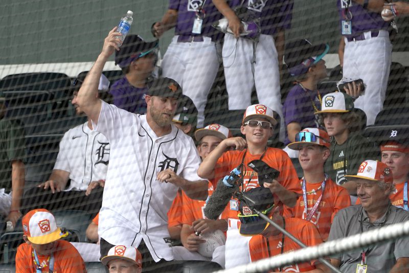 Detroit Tigers' Will Vest, left, dances with a Boerne, Texas, player in the stands of Volunteer Stadium during the middle of the third inning of a baseball game at the Little League World Series tournament in South Williamsport, Pa., Sunday, Aug. 18, 2024. (AP Photo/Tom E. Puskar)