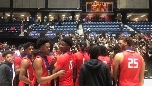 The Alexander basketball team celelbrates with their fans after winning the Class 6A championship, a 64-42 win over Lee County on March 10, 2023.