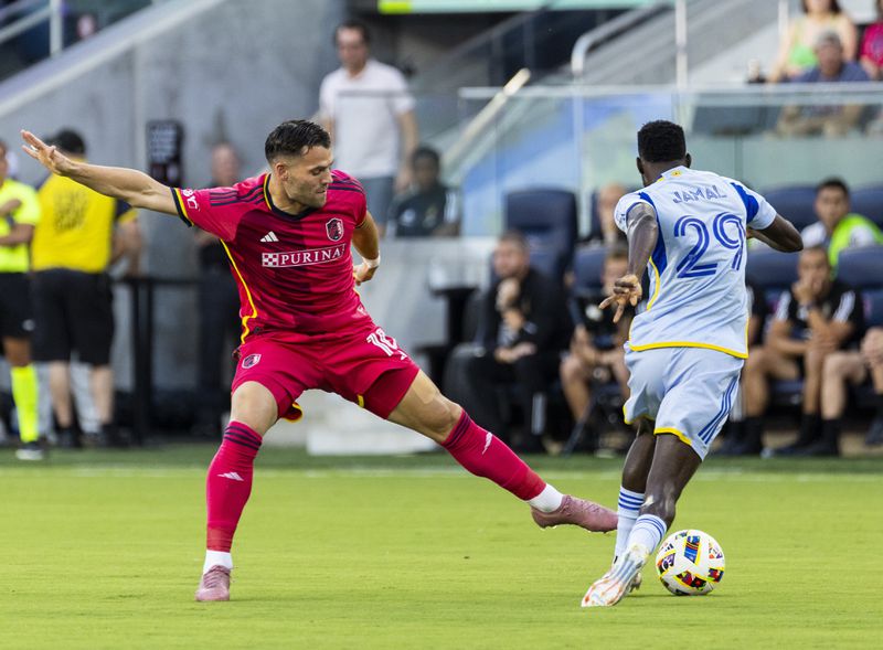 St. Louis City SC midfielder Eduard Löwen (10) attempts to keep the ball away from Atlanta United forward Jamal Thiaré (29) during the first half of an MLS soccer game at CityPark stadium in St. Louis on Saturday, June 22, 2024. (Dominic Di Palermo/St. Louis Post-Dispatch via AP)