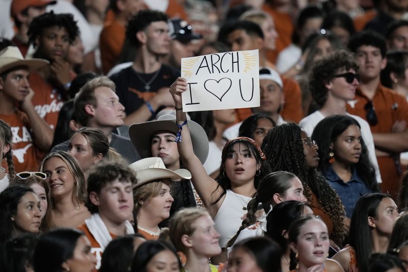 A fans holds a sign for Texas quarterback Arch Manning (16) during the first half of an NCAA college football game against Louisiana-Monroe in Austin, Texas, Saturday, Sept. 21, 2024. (AP Photo/Eric Gay)