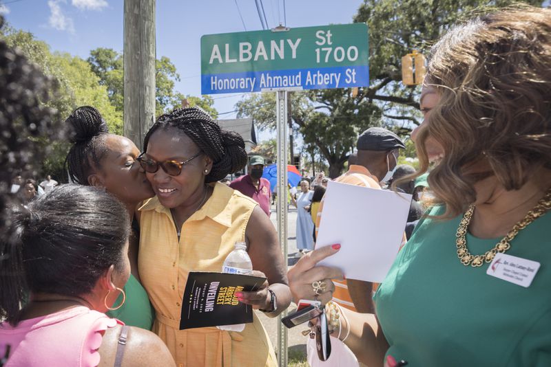 BRUNSWICK, GA - AUGUST, 9, 2022: Ahmaud Arbery's mother Wanda Cooper-Jones, center, is kissed by her friend Dana Roberts the day after the three men responsible for her son's death were sentenced on federal hate crimes charges. (AJC Photo/Stephen B. Morton)