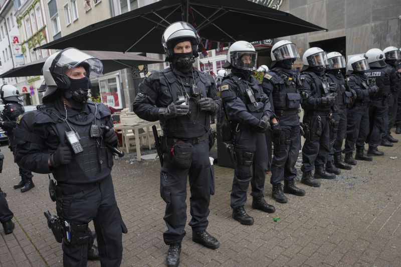 Riot police stand guard on the street ahead the Group C match between Serbia and England at the Euro 2024 soccer tournament in Gelsenkirchen, Germany, Sunday, June 16, 2024. (AP Photo/Markus Schreiber)