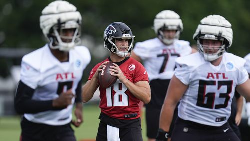 Atlanta Falcons quarterback Kirk Cousins (18) throws a pass during an NFL training camp football practice Friday, July 26, 2024, in Flowery Branch, Ga. (AP Photo/John Bazemore)