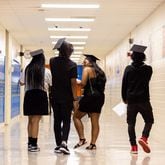 Students walk down the hall after Columbia High School's half-cap ceremony in Decatur on Thursday, May 16, 2024. The ceremony is for sophomores who are on track to graduate in two more years. (Arvin Temkar / AJC)