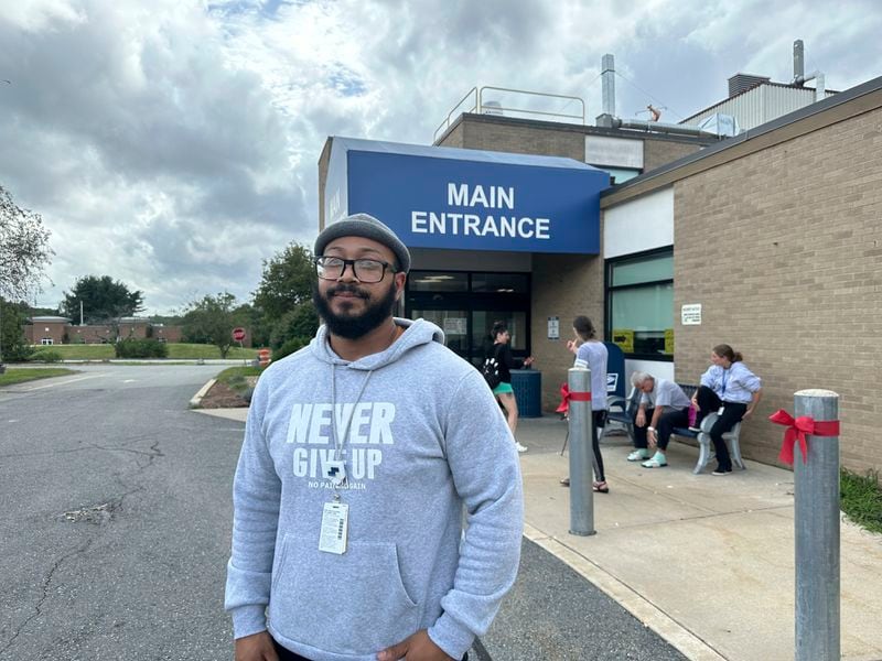 Michael Santos, a security guard, stands outside the Nashoba Valley Medical Center in Ayer, Mass., on Friday, Aug. 9, 2024. (AP Photo/Nick Perry)