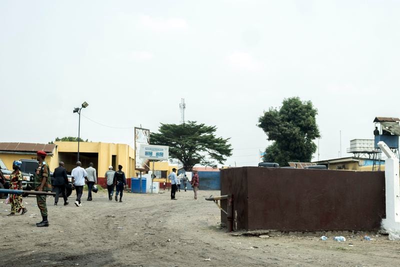 People walk past the Makala Central prison in Kinshasa, Congo, Tuesday, Sept. 3, 2024, after an attempted jailbreak in Congo’s main prison that left many people dead. (AP Photo/Samy Ntumba Shambuyi)