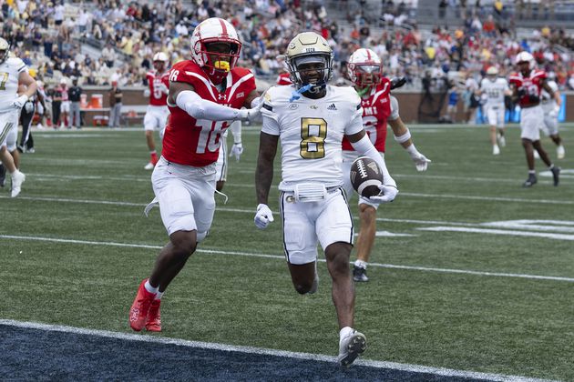 Georgia Tech wide receiver Malik Rutherford (8) runs in for a touchdown as Virginia Military Institute cornerback Asa Locks (16) defends after a catch during the first half of a NCAA college football game Saturday, Sept. 14, 2024, in Atlanta. The Jackets cruised 59-7. (AP Photo/John Bazemore)