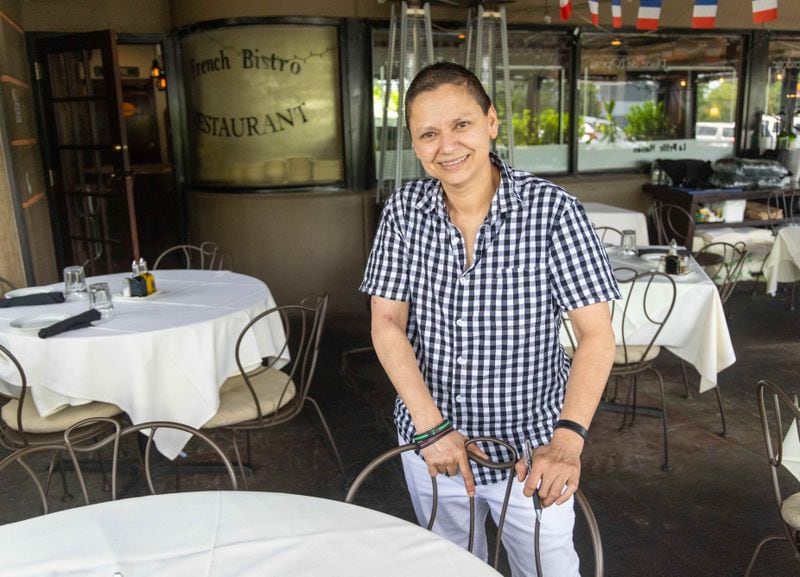 Kelly Youssef stands on the patio at La Petite Maison restaurant in Sandy Springs. PHIL SKINNER FOR THE ATLANTA JOURNAL-CONSTITUTION