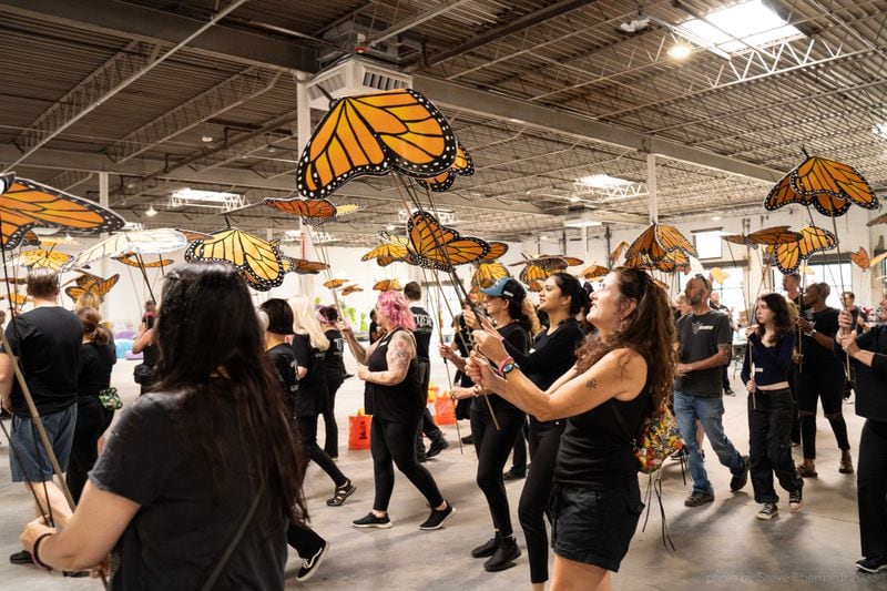 A group of 100 volunteer puppeteers practice animating their handmade monarch butterflies in preparation for a performance with the giant puppet Little Amal. Photo: Steve Eberhardt